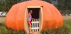 Girl standing in pumpkin house